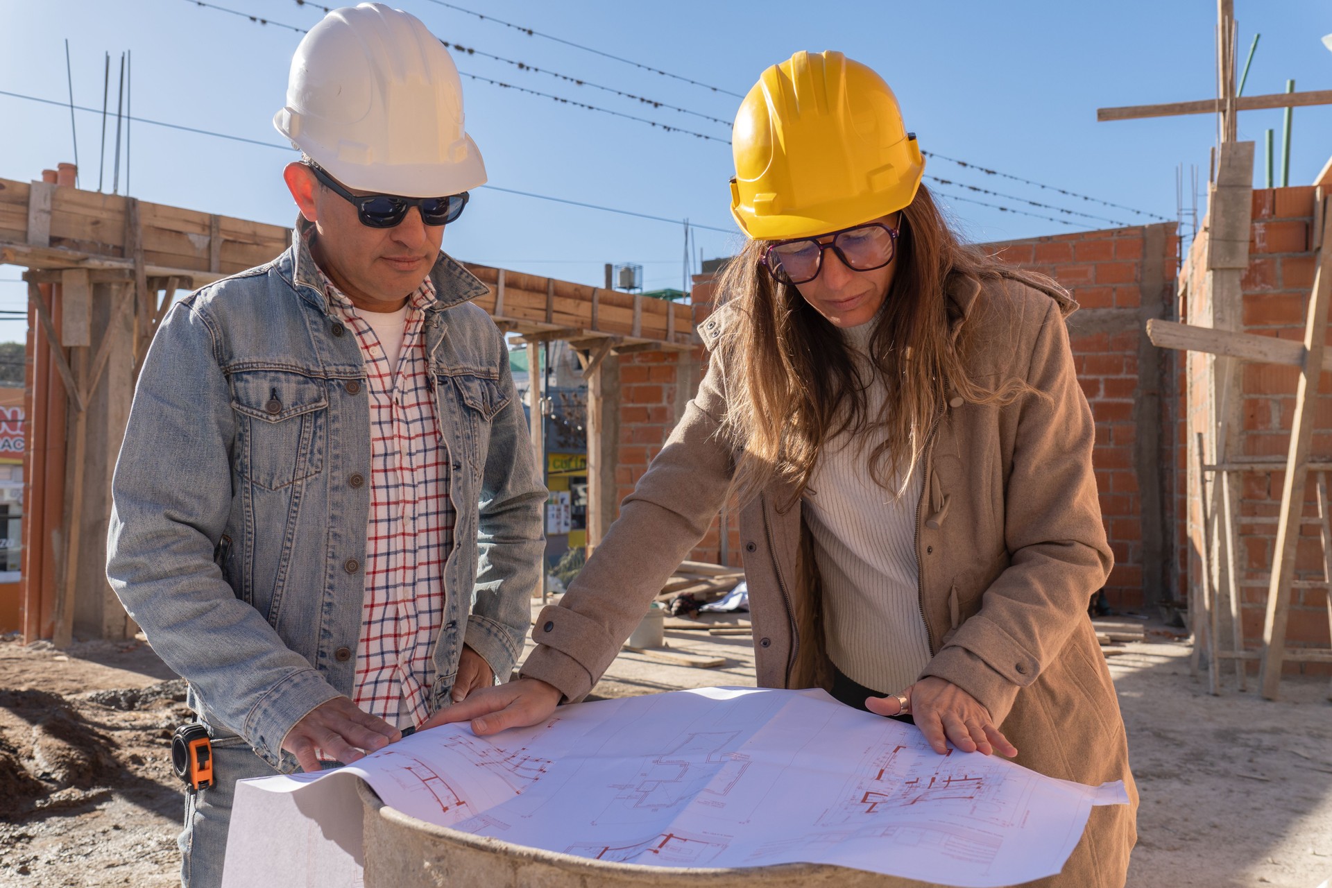 An architect and an engineer review the construction site plan.
